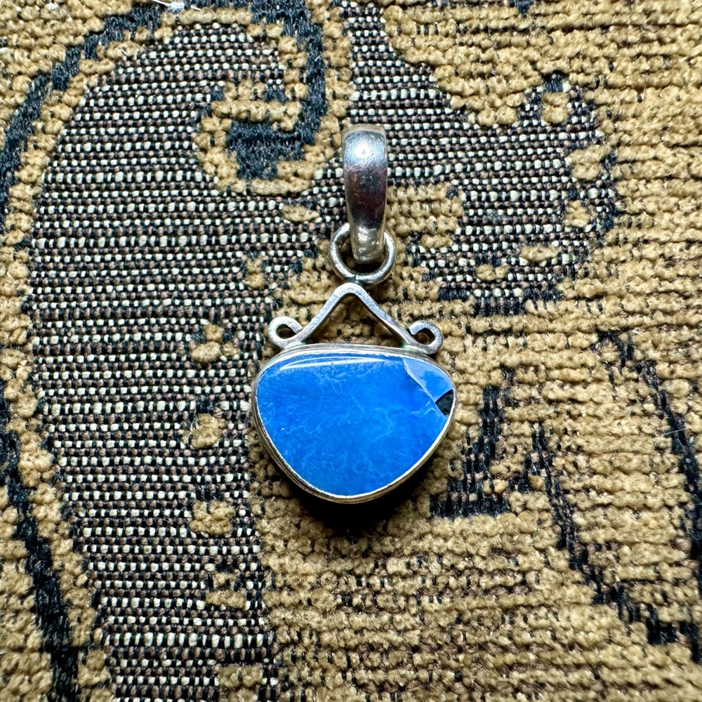 Hand crafted opal and sterling silver pendant.